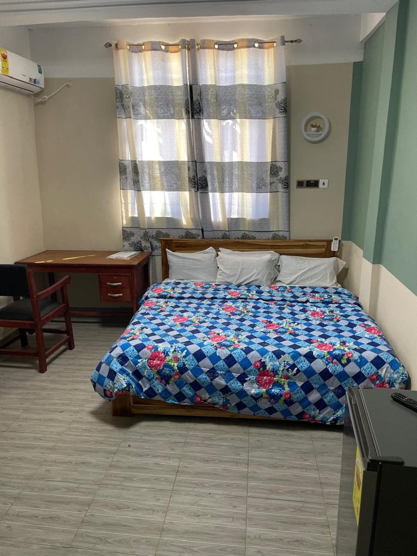 Standard room with double bed, study desk, and private bathroom at Equal Hotel